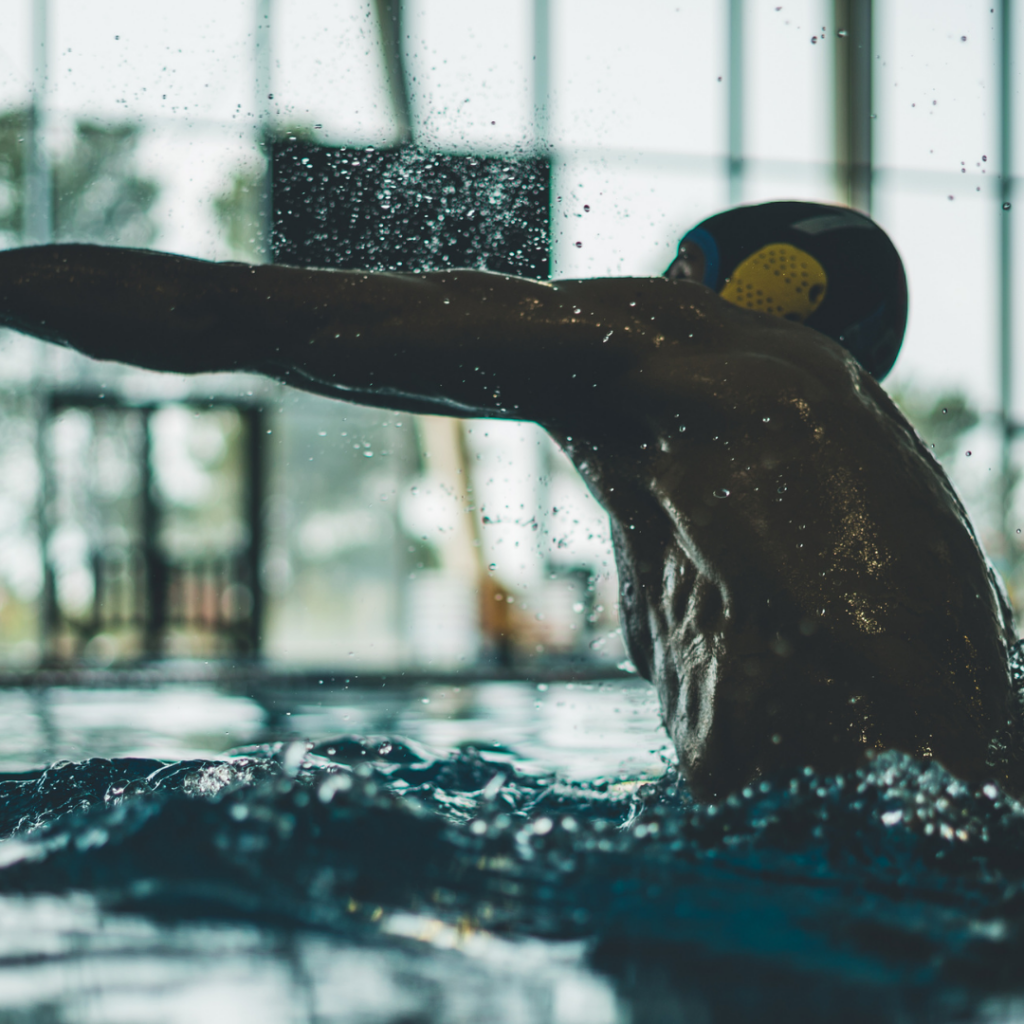 Why are swimming caps not designed to keep your hair dry?