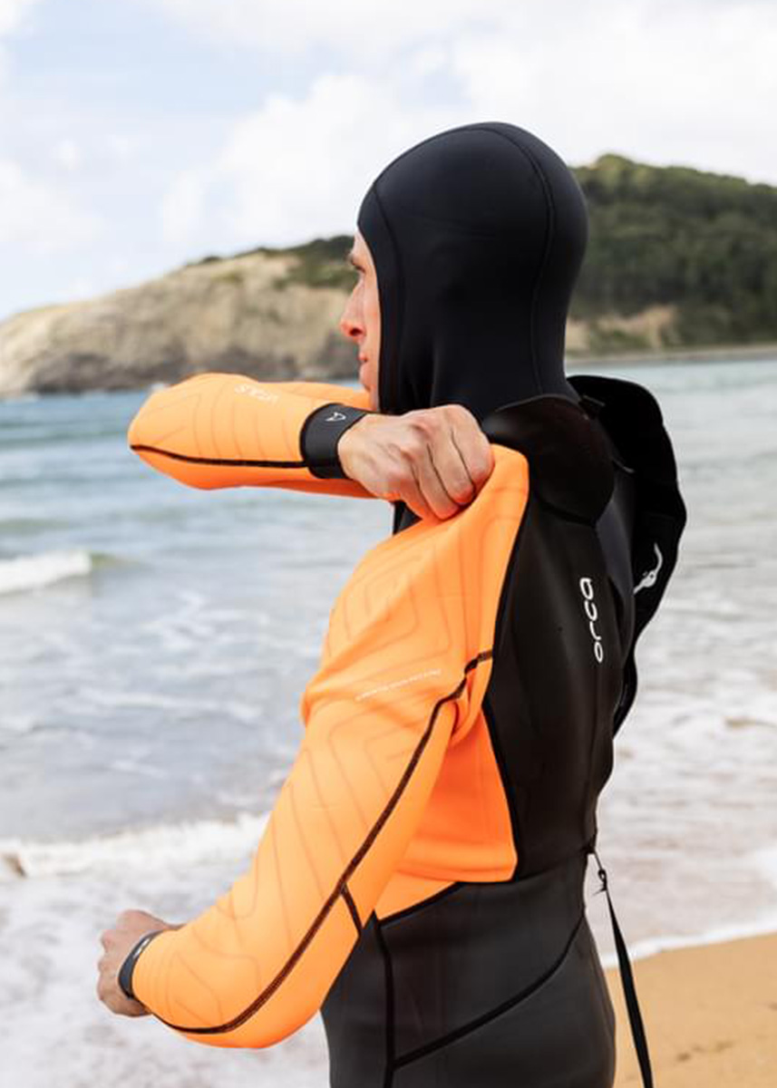 Man putting on Orca Vitalis Hi-Vis Wetsuit