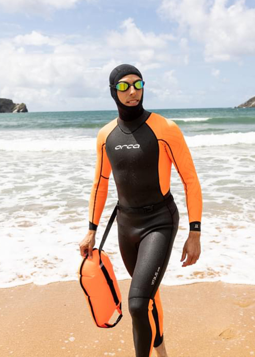 Man wearing Orca Vitalis Hi-Vis Wetsuit at the beach