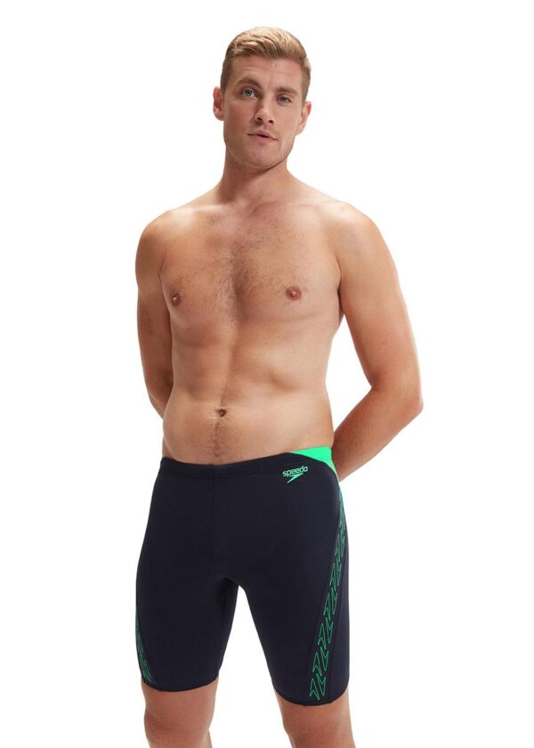 Man with his hands behind back wearing Speedo HyperBoom Splice Jammer - Navy / Green